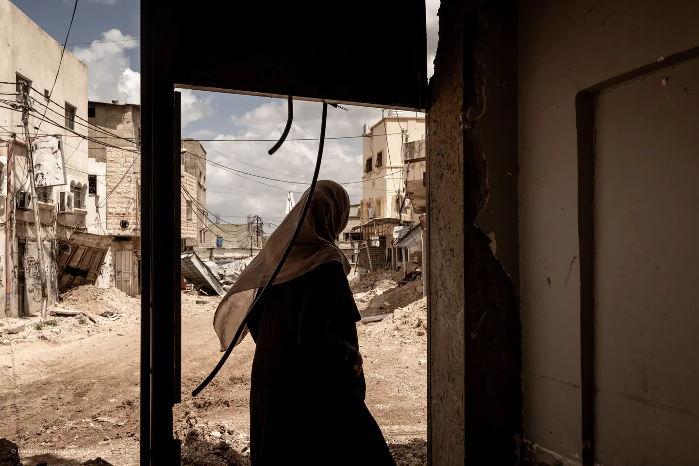 A Red Crescent volunteer walks through a damaged street in Tulkarm Refugee Camp.