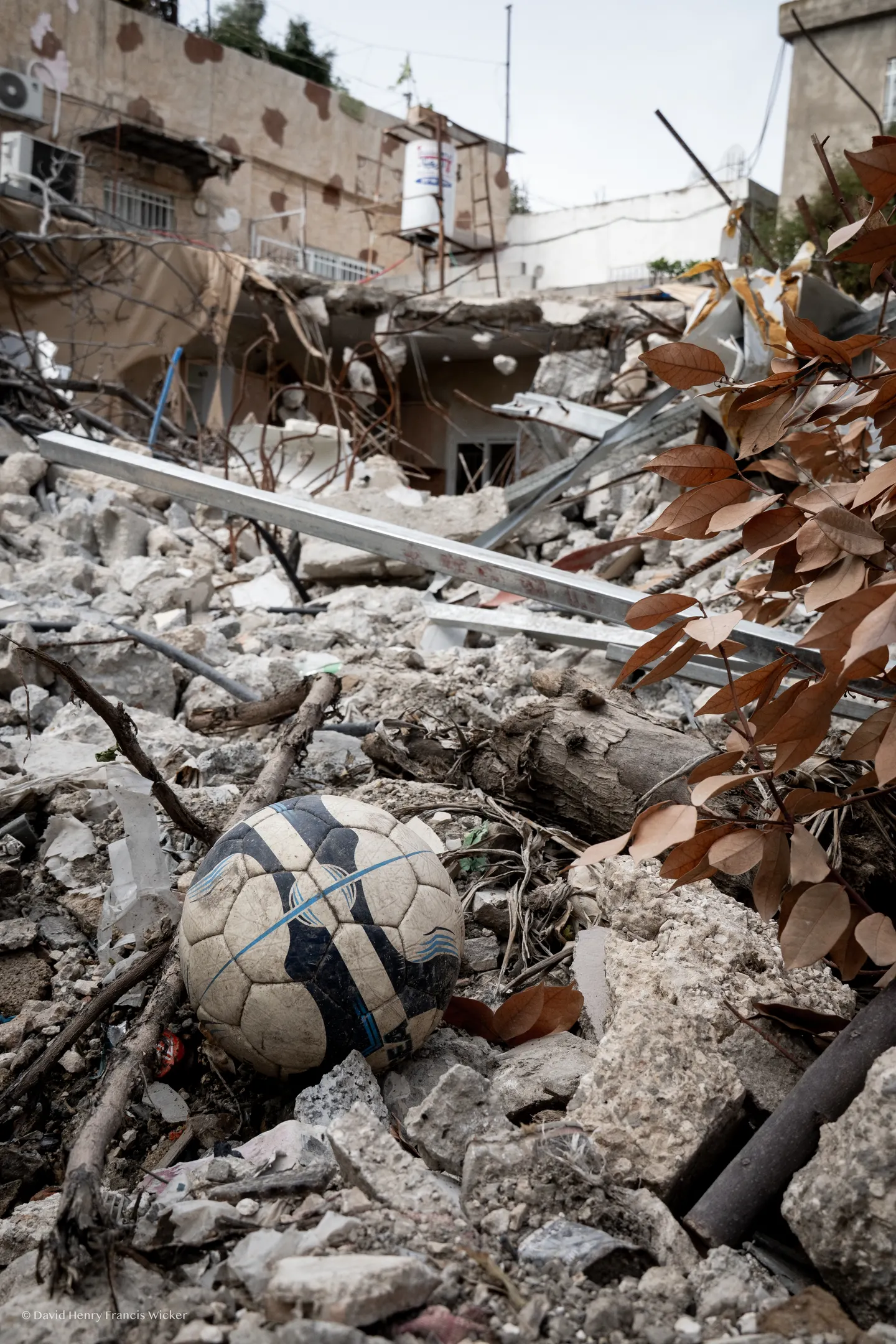A worn football rests among the remains of a demolished home in Silwan.